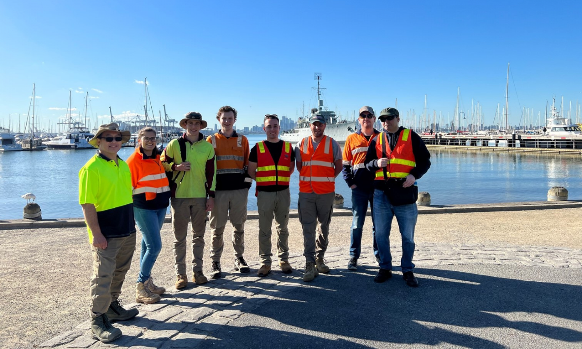 DCM staff standing in front of boats docked at Hobsons Bay